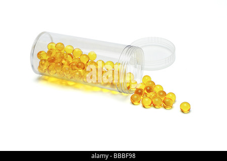 Medicine spilled from open container on white background Stock Photo