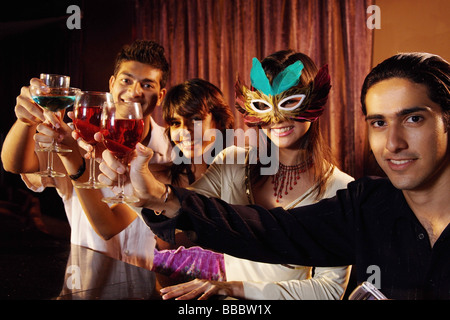 Couples at bar, toasting, looking at camera Stock Photo