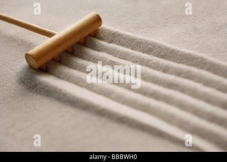 closeup of zen sand garden with rake Stock Photo
