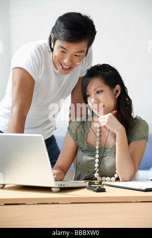 Young couple working at computer Stock Photo
