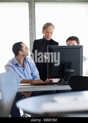 Group of business people at office desk Stock Photo