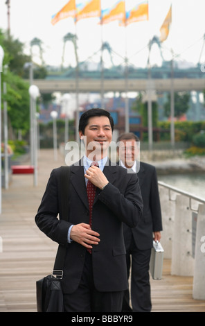 Businessmen walking on pier Stock Photo
