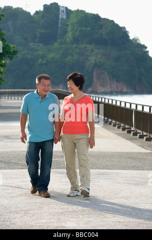 Couple strolling along the waterfront Stock Photo
