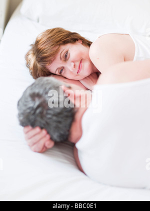 Eldery couple lying in bed smiling Stock Photo