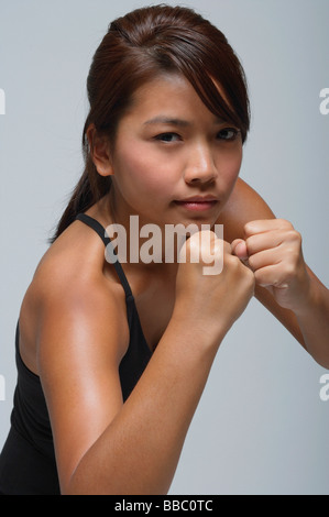 Young woman with fists up looking at camera Stock Photo