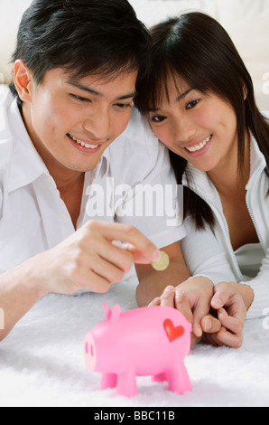 Young couple with piggy bank Stock Photo