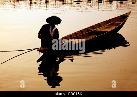 Vietnamese man on a wooden canoe in Hoi An Vietnam Stock Photo