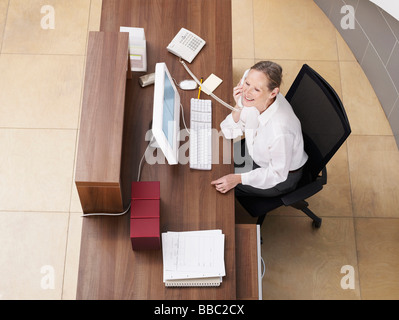 Office receptionist seen from above Stock Photo
