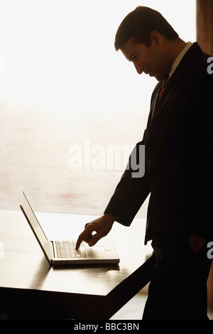 Asian businessman working on laptop computer in office Stock Photo