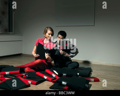 Man and woman playing with binders Stock Photo