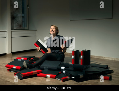 Woman in pile of binders Stock Photo