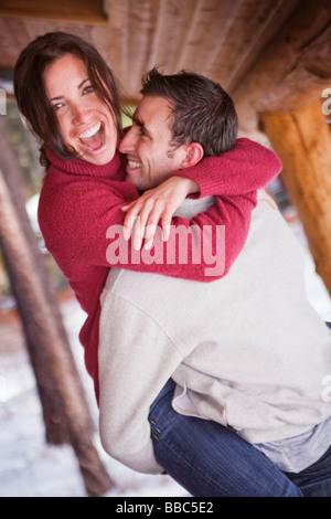 Man picking up laughing woman Stock Photo