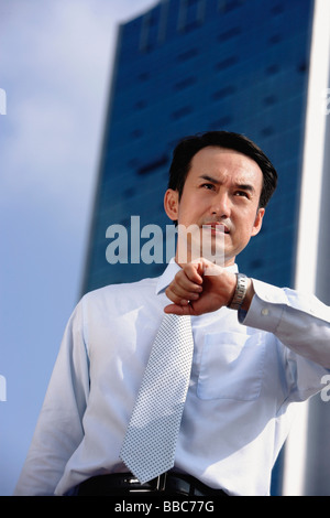 Businessman frowning, looking away Stock Photo