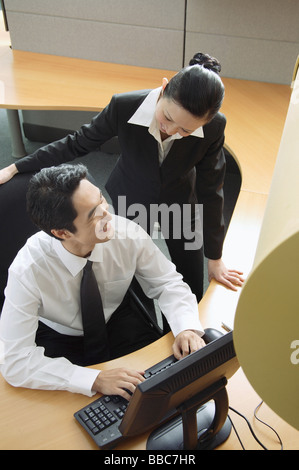Executives in cubicle talking Stock Photo
