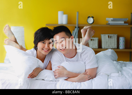 Couple lying on bed, portrait Stock Photo