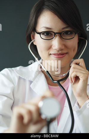Female doctor using stethoscope Stock Photo