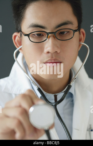 Doctor using stethoscope Stock Photo
