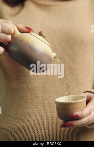 Woman pouring tea Stock Photo
