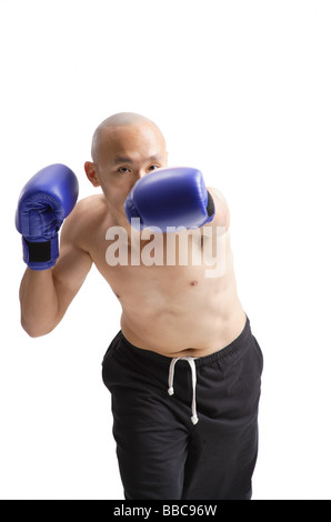 Young man wearing boxing gloves Stock Photo