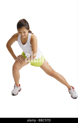 Young woman doing stretching exercises Stock Photo