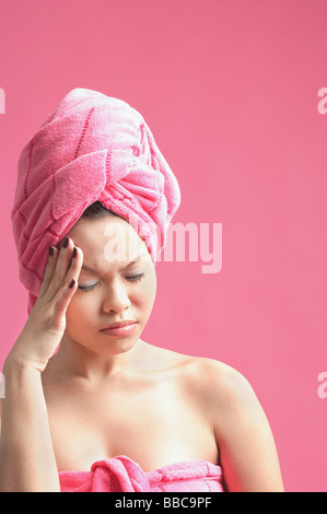 Woman wearing pink turban, frowning, eyes closed Stock Photo