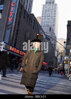 Woman crossing New York street Stock Photo