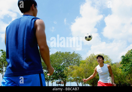 Two men playing soccer Stock Photo