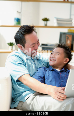 Father and son smiling each other Stock Photo
