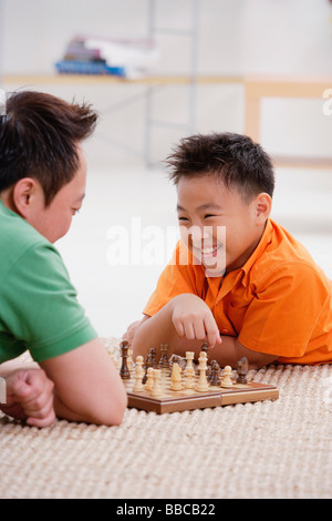 Father and son playing chess Stock Photo