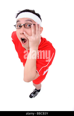 Man in soccer uniform looking at camera, hand on face Stock Photo