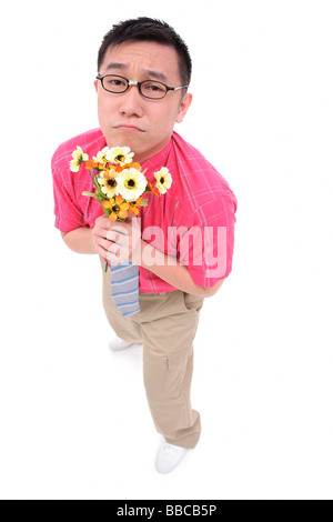 Man in shirt and tie holding flower bouquet, frowning Stock Photo