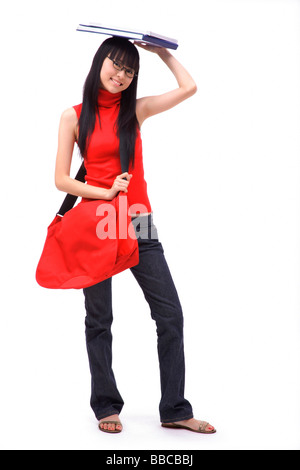 Young woman balancing book on head Stock Photo