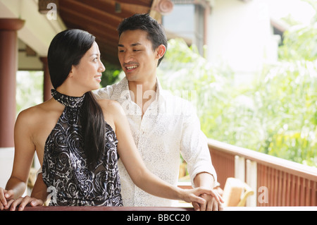 Couple standing, looking at each other Stock Photo