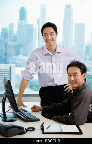 Male executives in office, smiling at camera Stock Photo