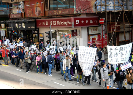 unhappy workers in street, Hong Kong island, China Stock Photo