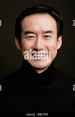 Man smiling, head shot, black background Stock Photo