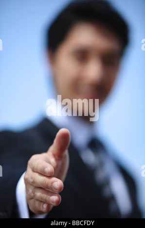 Businessman offering hand for handshake, selective focus Stock Photo