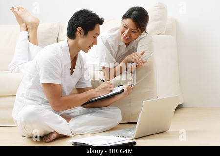 Couple at home in living room, doing home finances Stock Photo