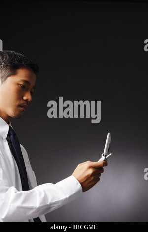 Young executive, using mobile phone Stock Photo