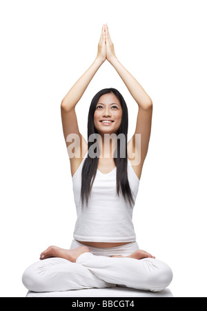 Woman practicing yoga, smiling Stock Photo