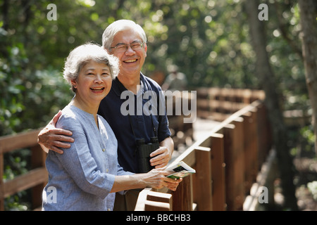 Mature couple side by side, smiling, looking at camera Stock Photo