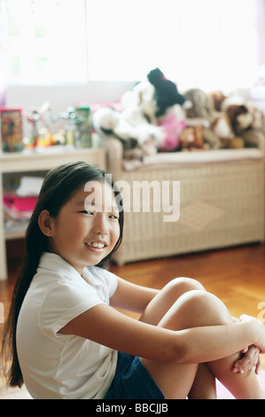 Girl sitting on floor, nude, hugging knees Stock Photo - Alamy