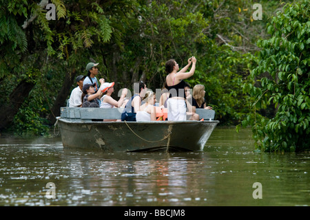 Eco tourists on the Kinabatangan river looking at wildlife, Malaysia, Borneo Stock Photo