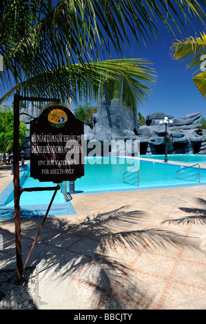 Sign in Vietnamese and English advising 37 degrees Celsius Hot Water Pool For Adults Only. Binh Chau hot springs, Vietnam Stock Photo