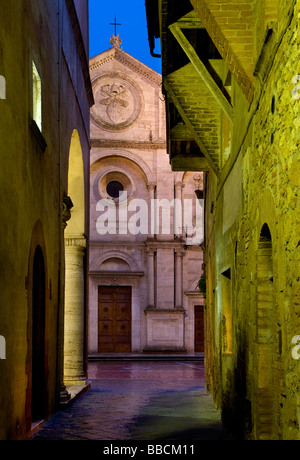 Narrow street and collegiate of San Quirico at night in village of Pienza, Tuscany, Italy Stock Photo