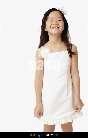 Girl in white dress, smiling at camera Stock Photo - Alamy