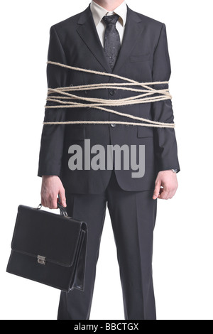 Businessman tied up with a rope, holding a briefcase Stock Photo