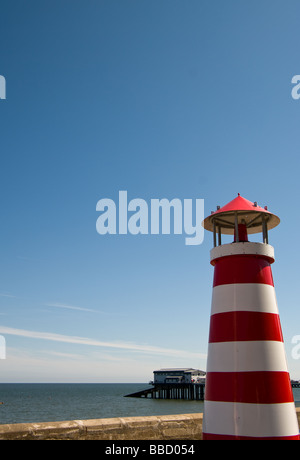A lighthouse on some fairground amusements standing in for the real Cromer lighthouse Stock Photo