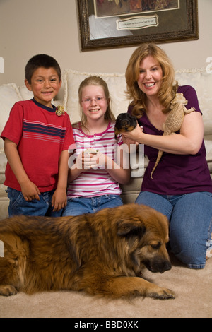 adoptionFamily with adopted foster child Mexican Hispanic boy adopts adoption adopting pets front MR  © Myrleen Pearson Stock Photo