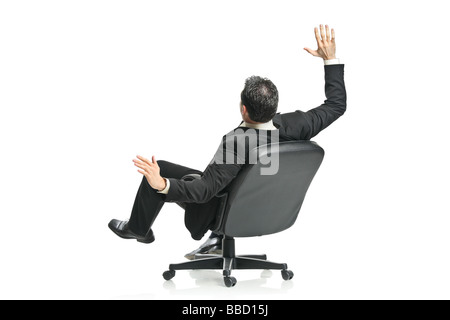 Man on a chair against white background Stock Photo